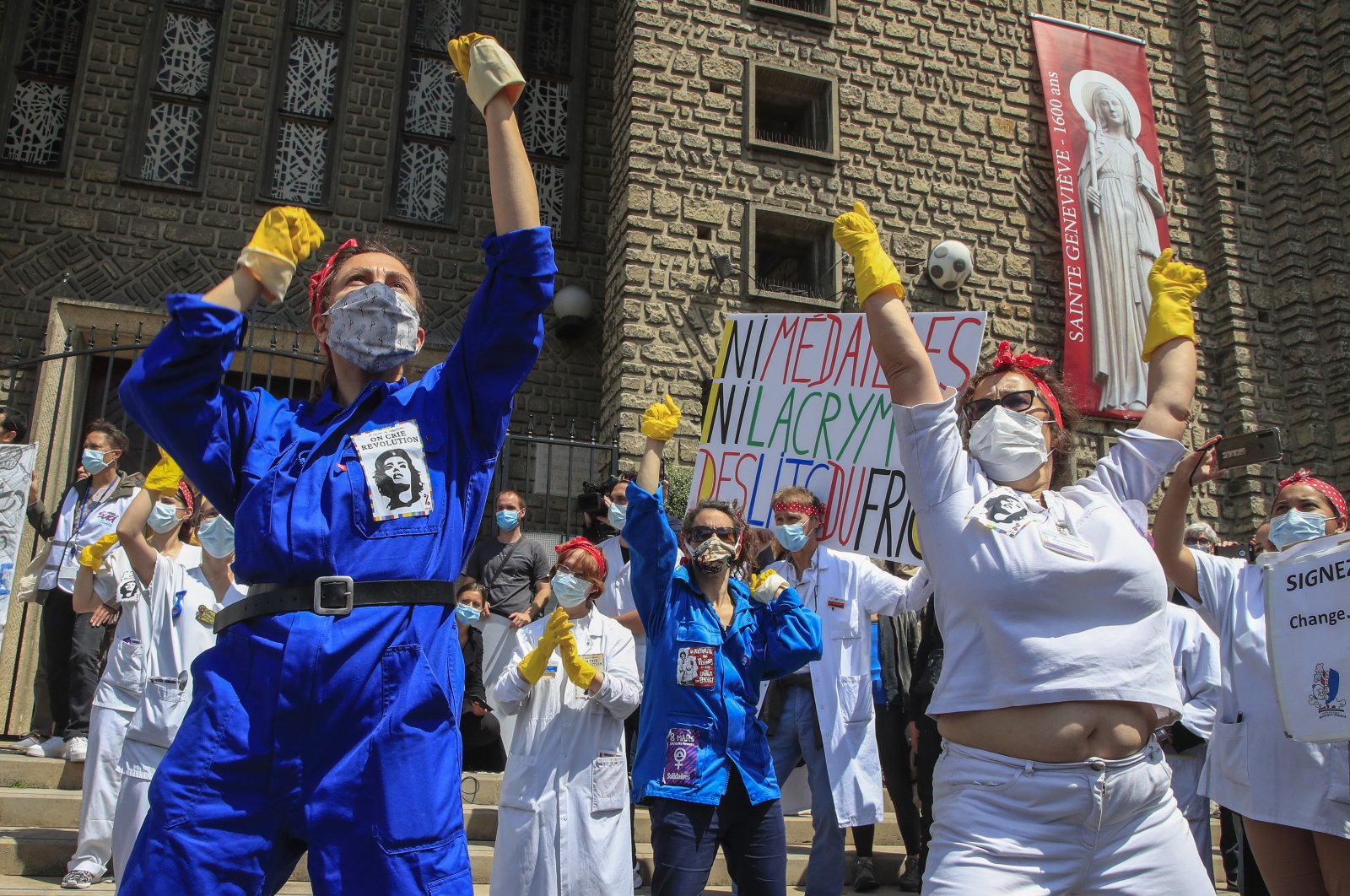 Medical personnel from the Robert Debre hospital, wearing masks to help curb the spread of the coronavirus, stage a protest in Paris, France, June 11, 2020. (AP Photo)
