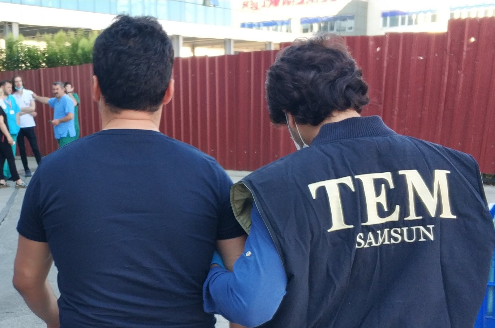 A police officer escorts a FETÖ suspect after his arrest, in Samsun, Turkey, June 16, 2020. (IHA Photo)