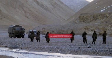 In this file photo, Chinese troops hold a banner that reads: "You've crossed the border, please go back" in Ladakh, India, May 5, 2013. (AP Photo)