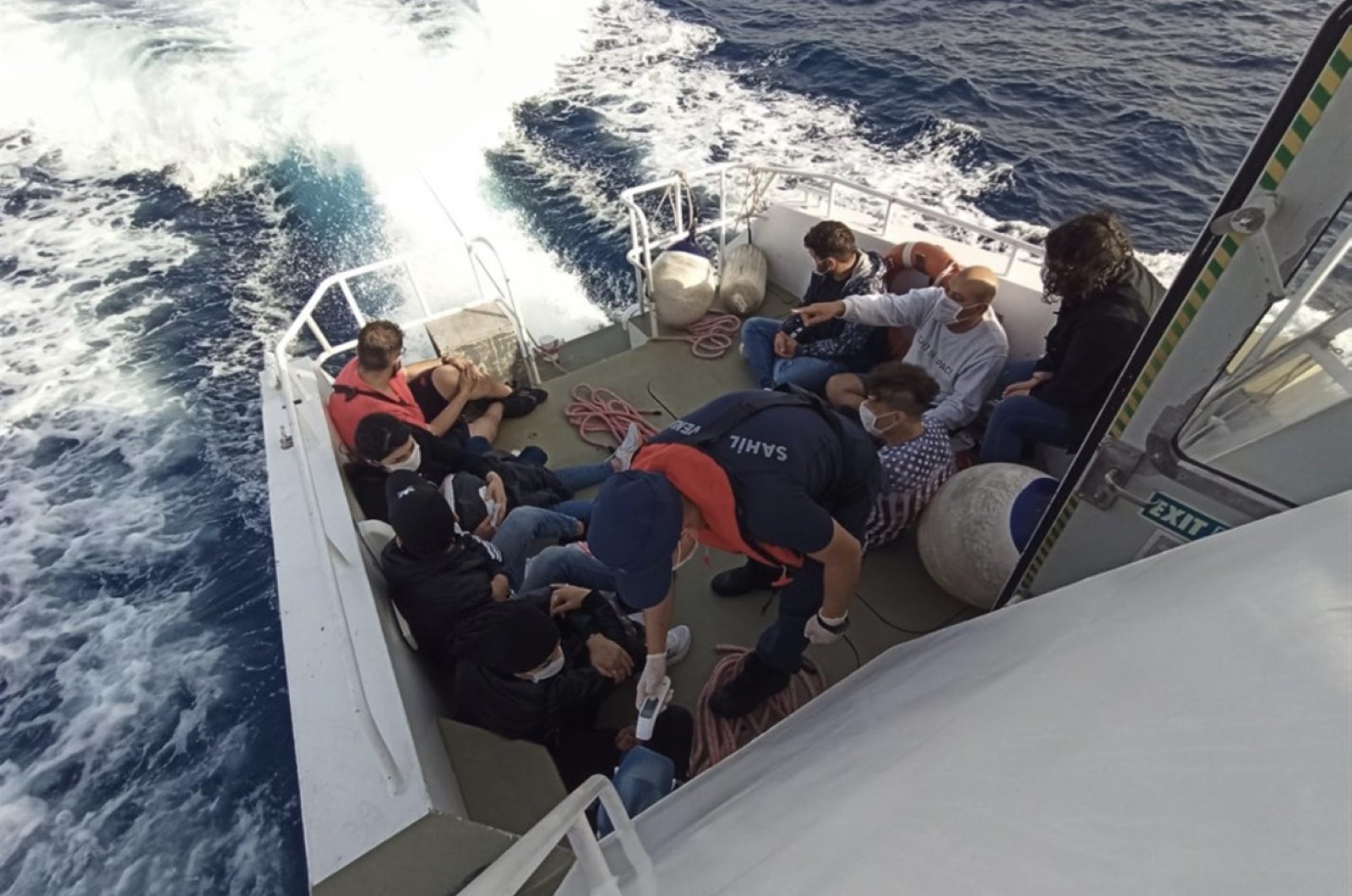 The Turkish Coast Guard rescue 10 asylum-seekers from a boat off the coast of Bodrum, Muğla province, Turkey, June 17, 2020. (İHA Photo)