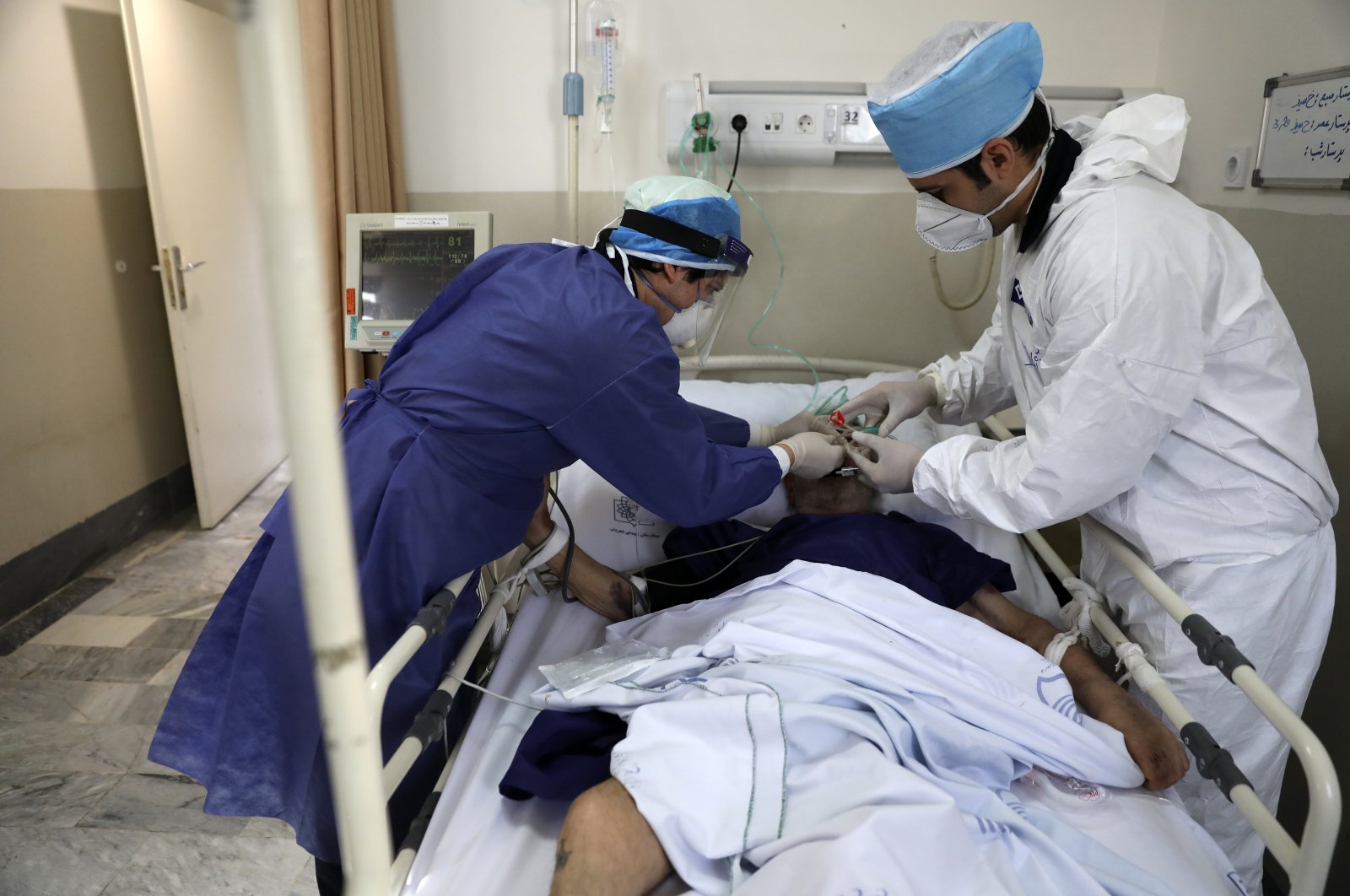 Medics tend to a COVID-19 patient at the Shohadaye Tajrish Hospital in Tehran, Iran, June 16, 2020. (AP Photo/Vahid Salemi)