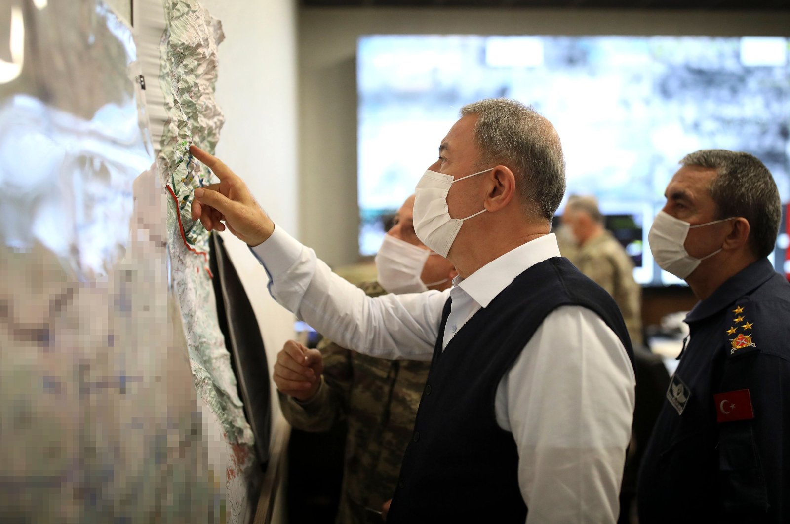 Defense Minister Hulusi Akar looks at a map with members of the Turkish Armed Forces Command during a meeting at the Army Command Control Center in Ankara during the military operation dubbed "Claw-Tiger" on June 17, 2020. (AFP Photo)