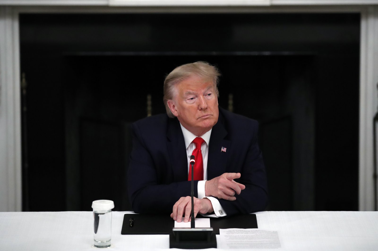 President Donald Trump listens during a roundtable with governors on the reopening of America's small businesses, in the State Dining Room of the White House, Thursday, June 18, 2020, in Washington. (AP Photo)