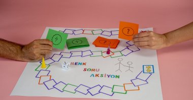 Fathers and their children can play “Color, Question, Action!” with materials easily found in every home. 