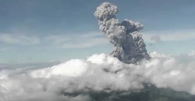 This handout photo taken and released on June 21, 2020 by Indonesia's Research and Technology Development for Geological Hazard Mitigation (BPPTKG) shows the Merapi Mount volcano spewing thick smoke into the air as seen from Yogyakarta. 
