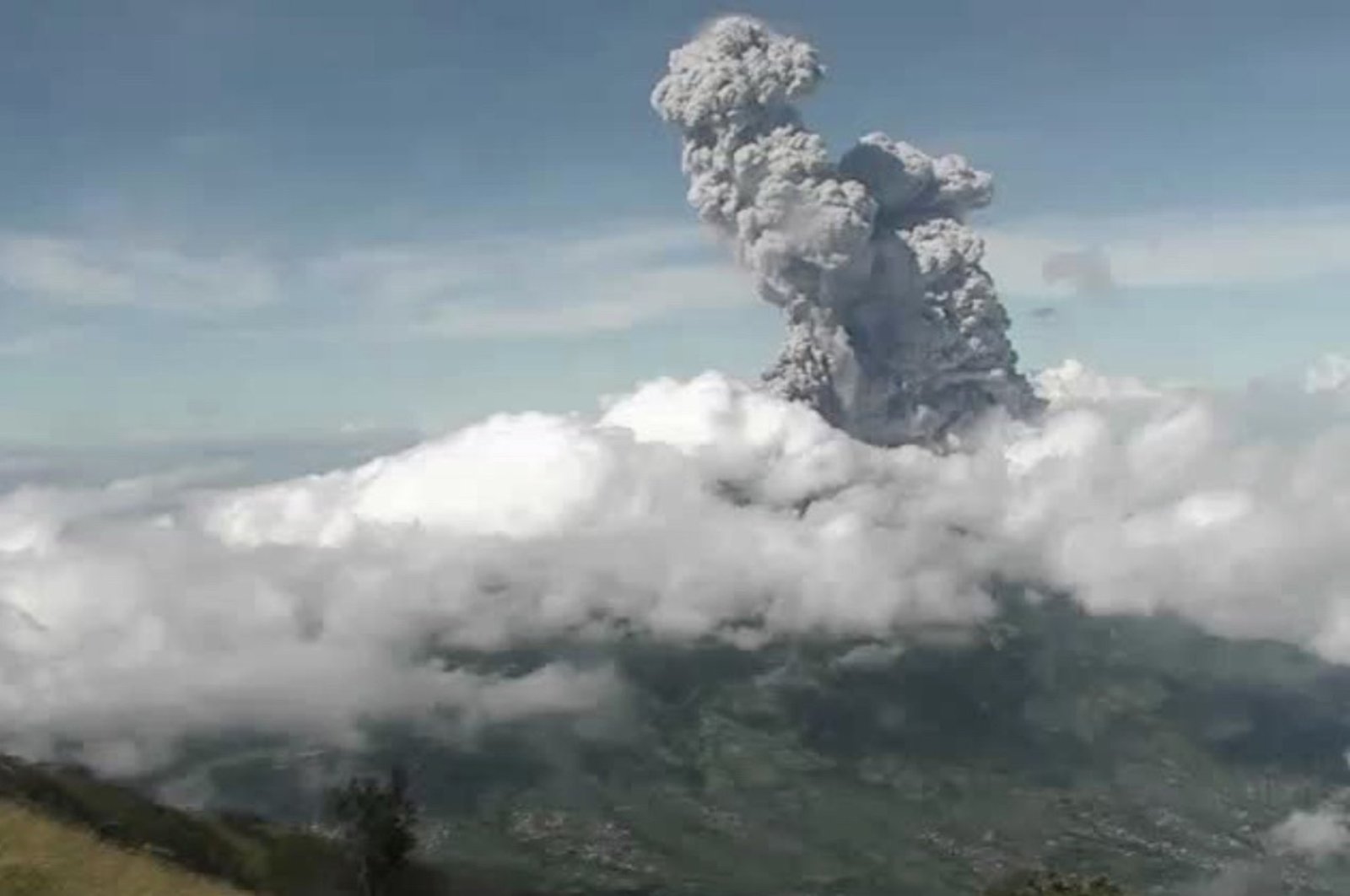 This handout photo taken and released on June 21, 2020 by Indonesia's Research and Technology Development for Geological Hazard Mitigation (BPPTKG) shows the Merapi Mount volcano spewing thick smoke into the air as seen from Yogyakarta. 