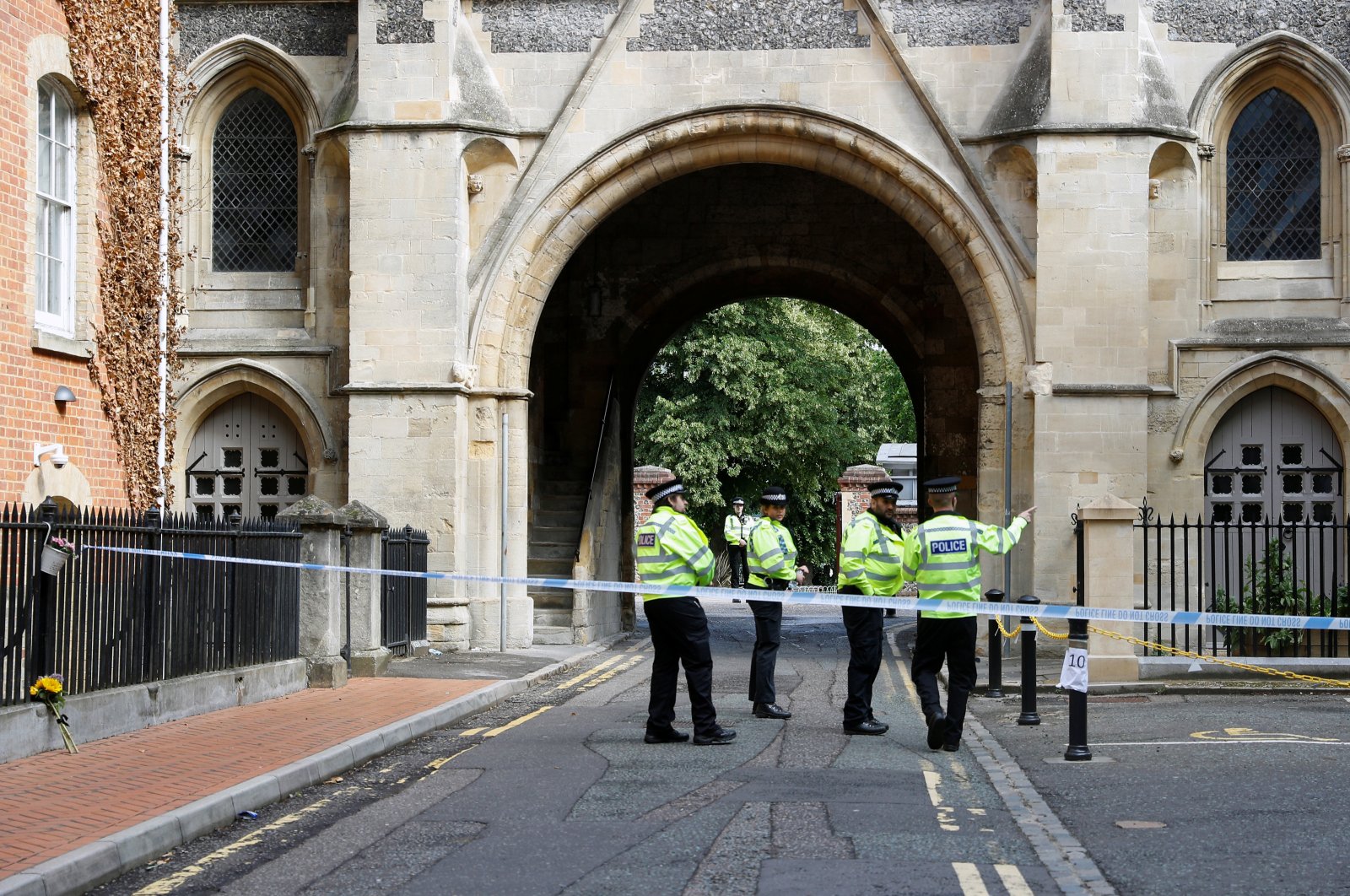 Police officers stand behind the cordon at the scene of multiple stabbings, Reading, England, June 21, 2020. (Reuters Photo)