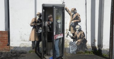 In this file photo, a new graffiti street art piece, suspected of being a Banksy, appears in Cheltenham, England, April 14, 2014. (AP Photo)