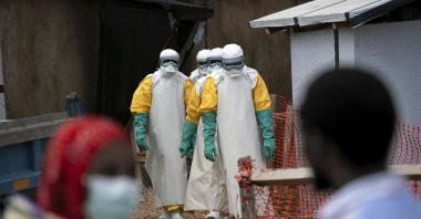 Health workers wearing protective gear begin their shift at an Ebola treatment center, Beni, Democratic Republic of Congo, July 16, 2019. (AP Photo)