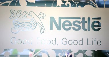 Nestle logo is pictured on the door of the supermarket of Nestle headquarters in Vevey, Switzerland, Feb. 13, 2020. (Reuters Photo)