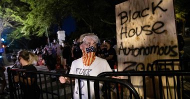 Protesters carry metal stanchions as they fortify a barricade they erected and marked with the sign "Black House Autonomous Zone" in front of Lafayette Park near the White House, in Washington, D.C., U.S., June 22, 2020. (AFP Photo)