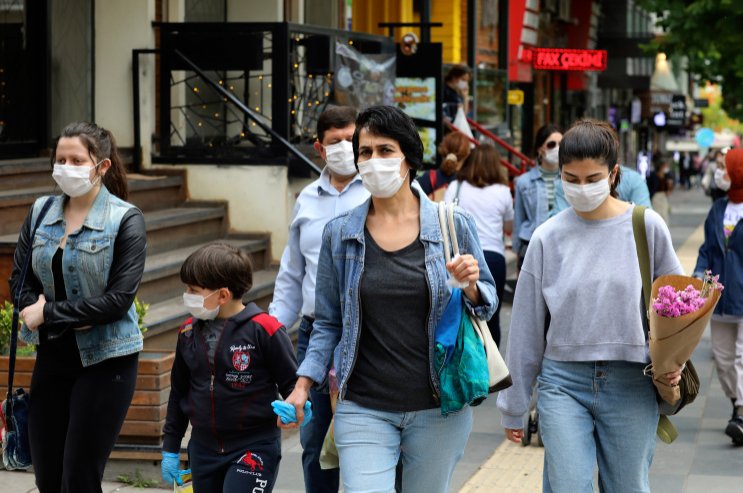 People wearing face masks to protect against the spread of coronavirus, walk in the city center, in Ankara, Turkey, June 20, 2020. (AP Photo)