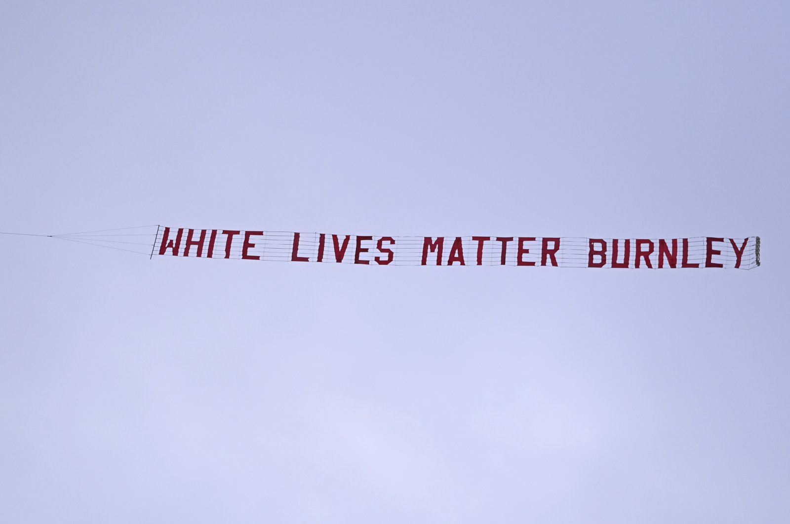 A plane towing a banner reading White Lives Matter Burnley flies above the stadium during the during the English Premier League football match between Manchester City and Burnley at Etihad Stadium, in Manchester, England, Monday, June 22, 2020. (AP Photo)