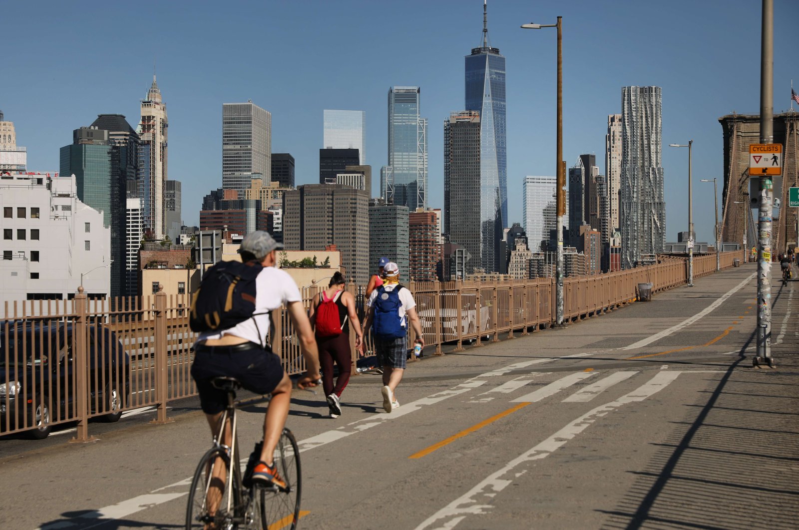 People are seen at the Brooklyn Bridge as Manhattan enters Phase 2 of reopening following restrictions imposed to curb the coronavirus pandemic, in New York, June 22, 2020. (Getty Images via AFP)