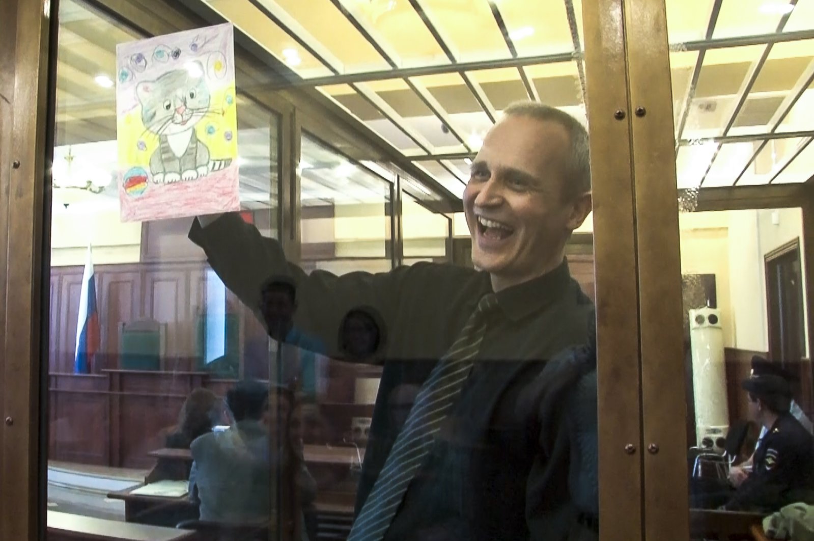In this file image taken from video, Dennis Christensen shows a picture in a courtroom in Oryol, Russia, May 23, 2019. (AP Photo)