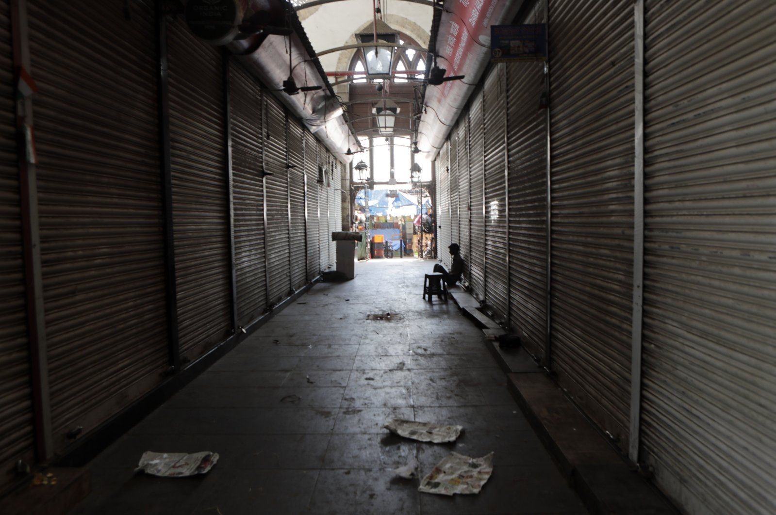 A man sits outside a closed wholesale market in Mumbai, India, March 24, 2020. (AP Photo)