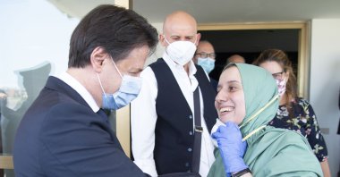 Silvia Romano, who was kidnapped 18 months ago in East Africa, is welcomed by Italian Prime Minister Giuseppe Conte in Rome, May 13, 2020. (AA)