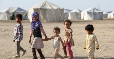 Children walk at a camp for people recently displaced by fighting in Yemen's northern province of al-Jawf between government forces and Houthis, in Marib, Yemen March 8, 2020. (Reuters Photo)