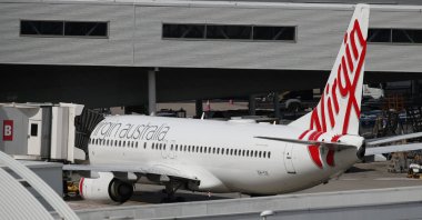 A Virgin Australia Airlines plane is seen at Kingsford Smith International Airport the morning after Australia implemented an entry ban on non-citizens and non-residents intended to curb the spread of the coronavirus disease (COVID-19) in Sydney, Australia, March 21, 2020. (Reuters File Photo)