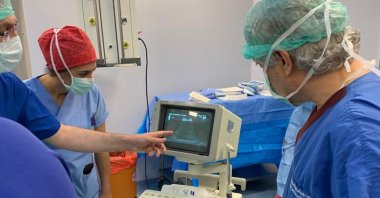 A group of doctors, including Prof. Ömer Özkan (R), make last checks as Derya Sert gives birth, June 26, 2020. (DHA Photo)