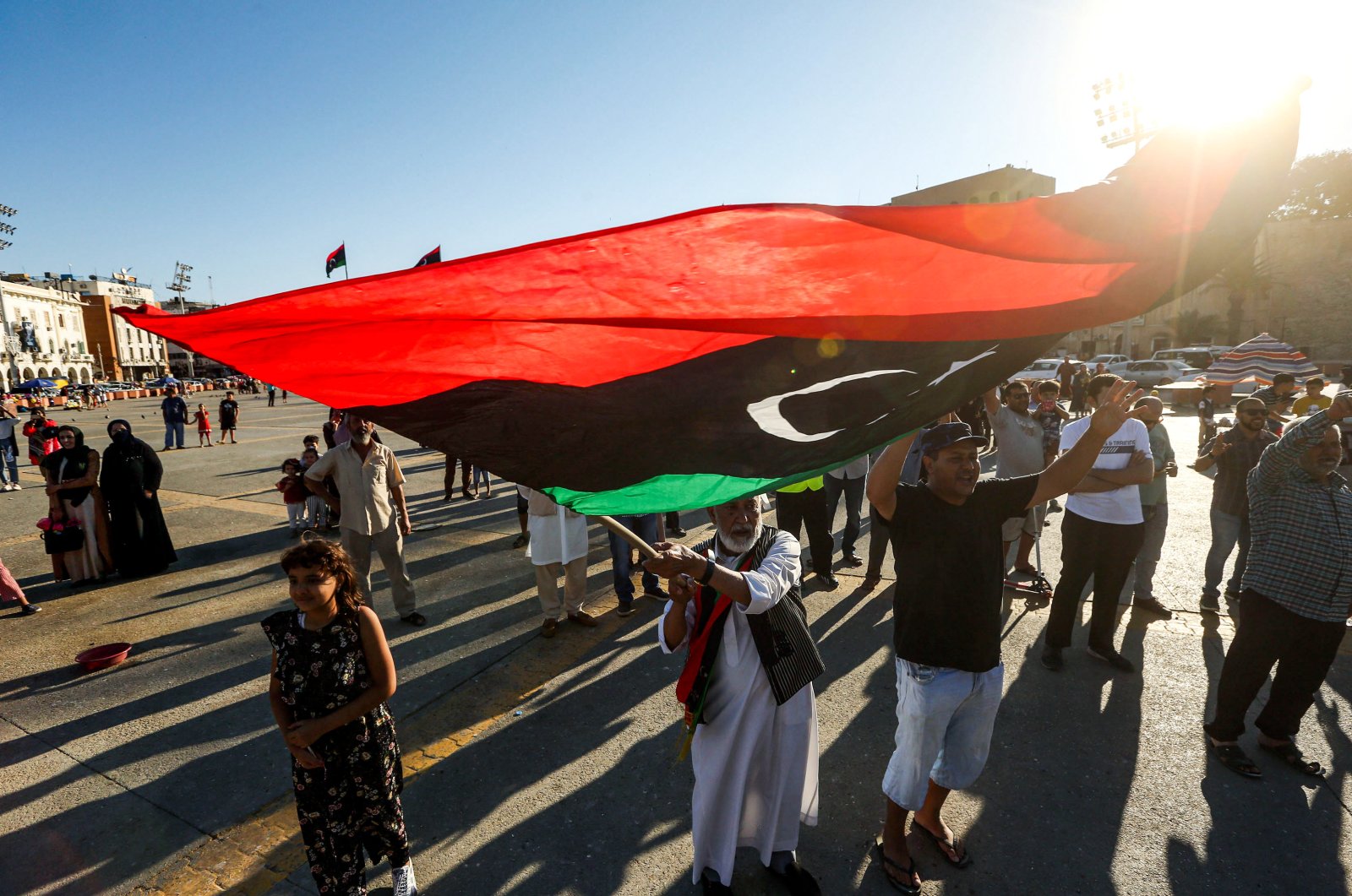 An elderly man waves a Libyan national flag during a demonstration in the Martyrs' Square in the centre of the Libyan capital Tripoli, June 21, 2020. (AFP Photo)

