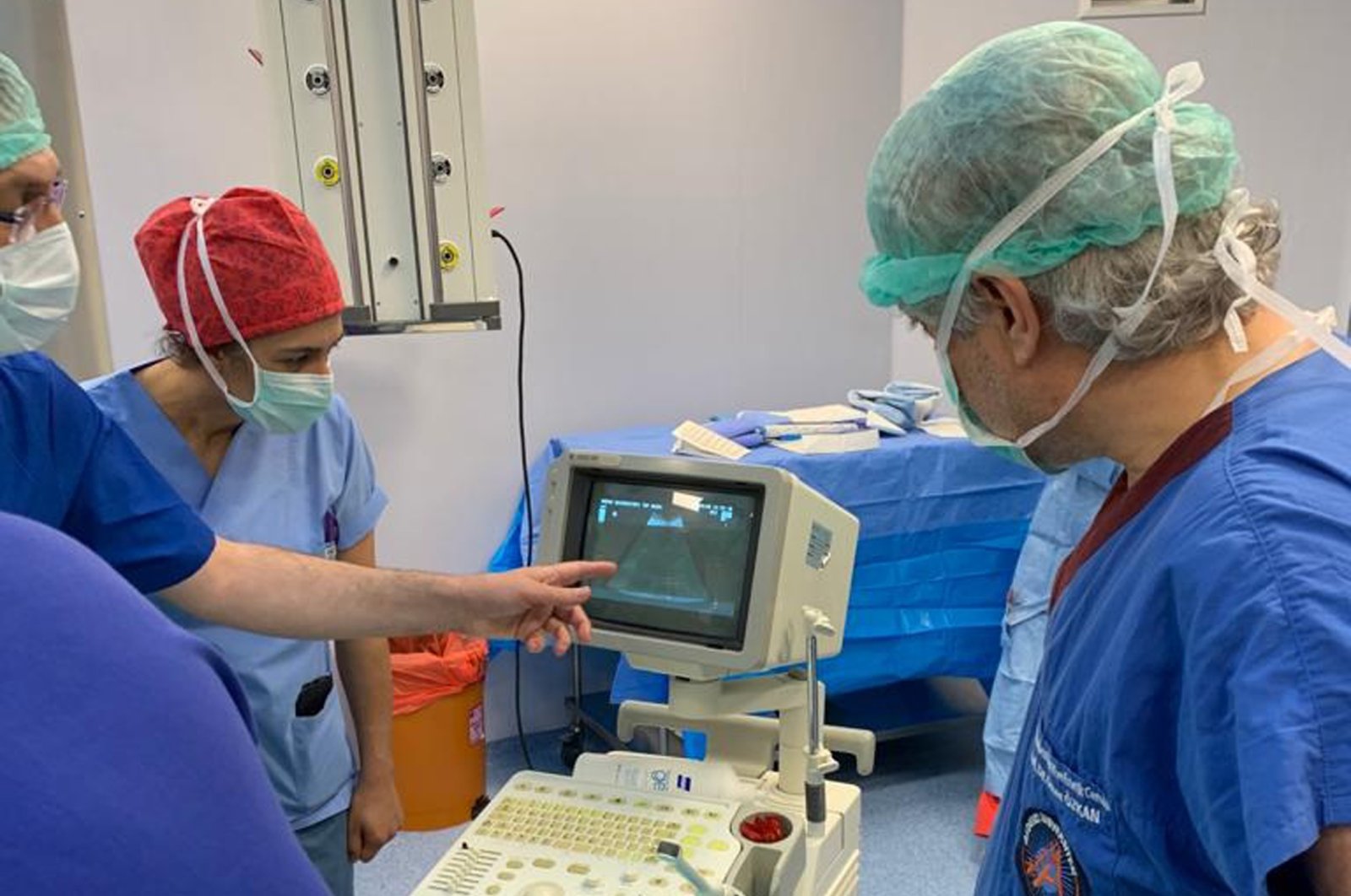 A group of doctors, including Prof. Ömer Özkan (R), make last checks as Derya Sert gives birth, June 26, 2020. (DHA Photo)