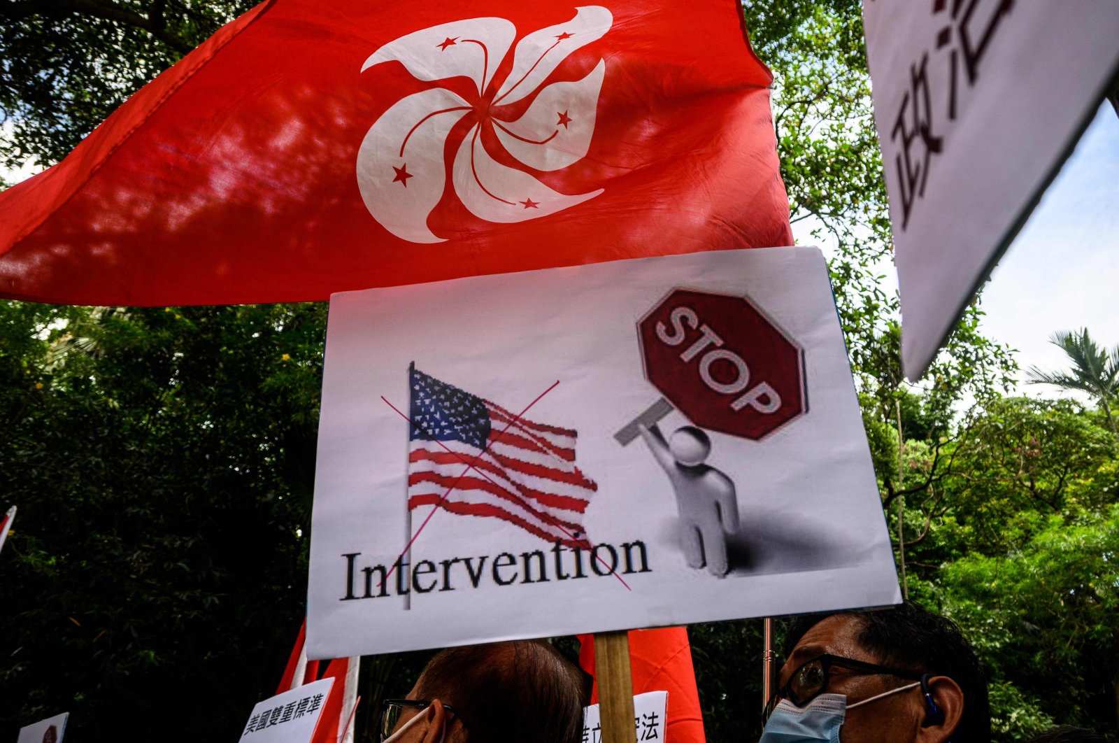 A group of activists hold placards and flags outside the US Consulate General in Hong Kong on June 26, 2020. (AFP Photo)