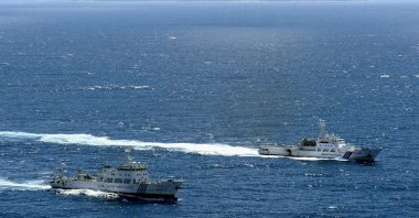 An aerial photo shows the Chinese marine surveillance ship Haijian No. 51 (L) cruising as a Japan Coast Guard ship Ishigaki sails near Uotsuri island, one of the disputed islands, called Senkaku in Japan and Diaoyu in China, in the East China Sea on Sept. 14, 2012. (Reuters Photo)