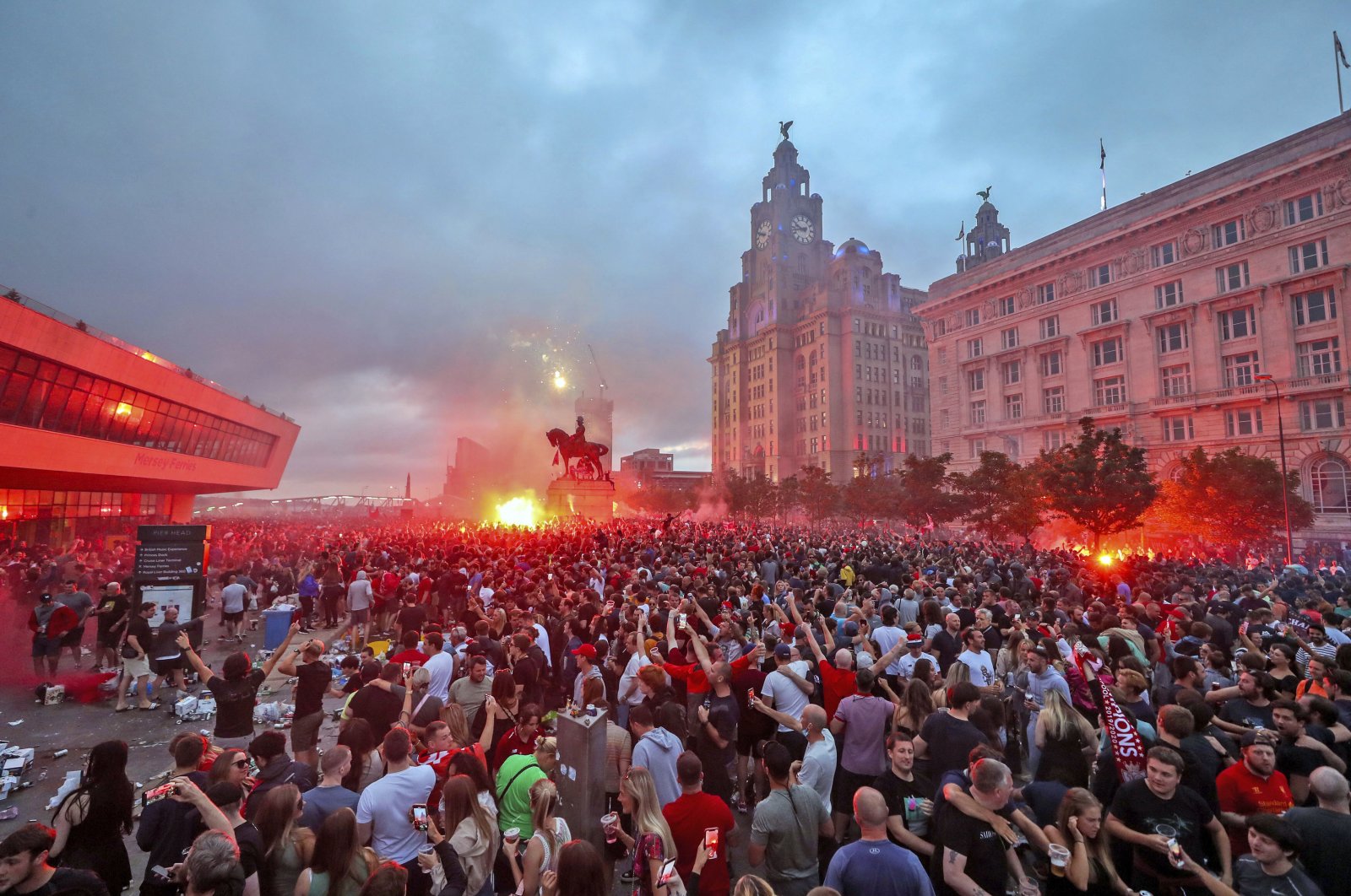 Liverpool fans let off flares outside the Liver Building in Liverpool, June 26, 2020. (AP Photo)