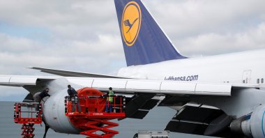 Employees work on a Lufthansa Boeing 747 at French aircraft storage and recycling company Tarmac Aerosave in Tarbes following the coronavirus disease (COVID-19) outbreak in France, June 19, 2020. (Reuters Photo)