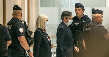 France's former Prime Minister Francois Fillon (R) and his wife Penelope wear protective masks as they arrive at Paris courthouse, Paris, June 29, 2020. (AP Photo)