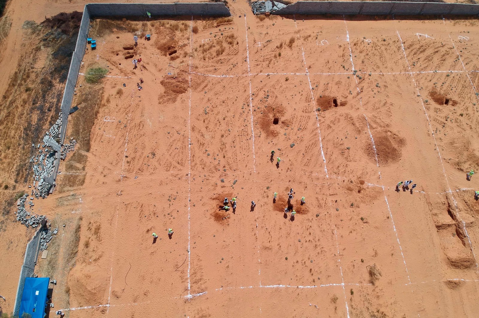 An aerial view shows Libyan experts searching for human remains during the exhumation of mass graves in Tarhuna, southeast of the capital Tripoli, Libya, June 23, 2020. (AFP Photo)