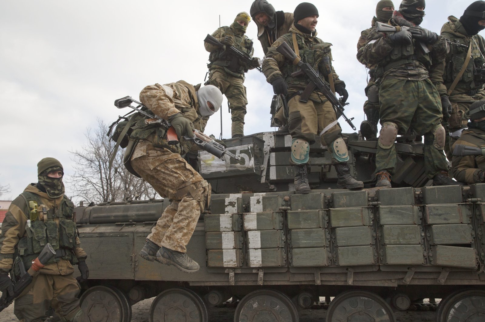 A Russia-backed rebel jumps off a tank in Donetsk, Ukraine, February 20, 2015. (AP Photo)