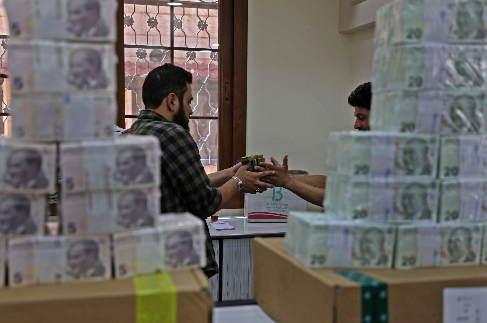 Employees sort Turkish lira banknotes at a bank in the town of Sarmada in Syria's northwestern Idlib province, June 14, 2020. (AFP Photo)