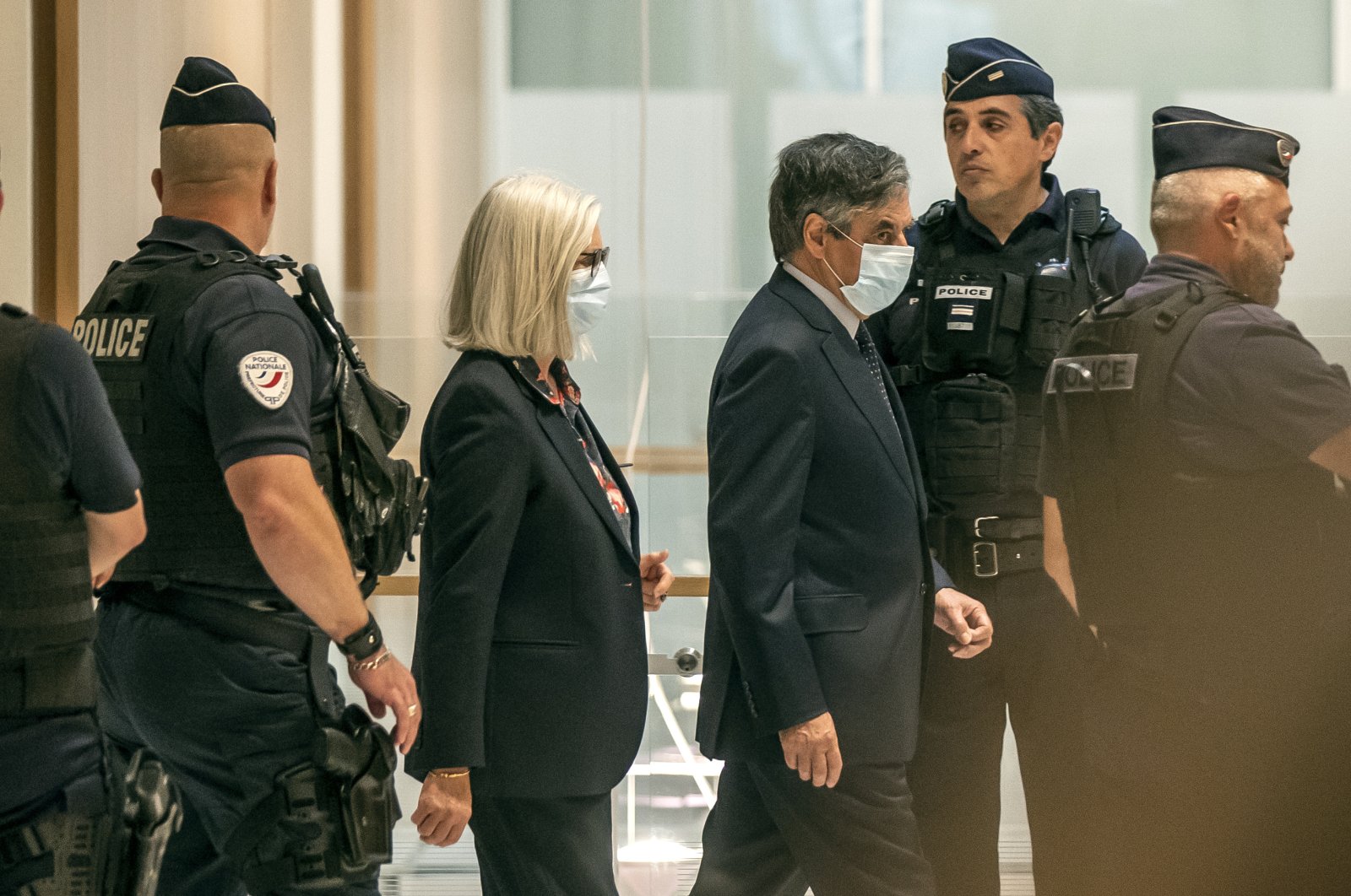 France's former Prime Minister Francois Fillon (R) and his wife Penelope wear protective masks as they arrive at Paris courthouse, Paris, June 29, 2020. (AP Photo)