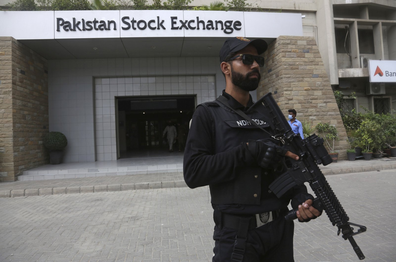 A police commando stands guard outside the Pakistan Stock Exchange after an attack in Karachi, Pakistan, June 29, 2020. (AP Photo)