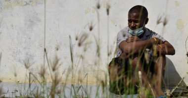 A Rohingya from Myanmar sits outside an immigration detention center in Lhokseumawe, in Indonesia's North Aceh Regency, June 26, 2020. (AFP Photo)