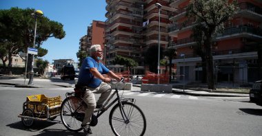 A man rides his bicycle near a residential complex where more than 40 people tested positive for the coronavirus disease (COVID-19), Mondragone, June 29, 2020. (REUTERS Photo)