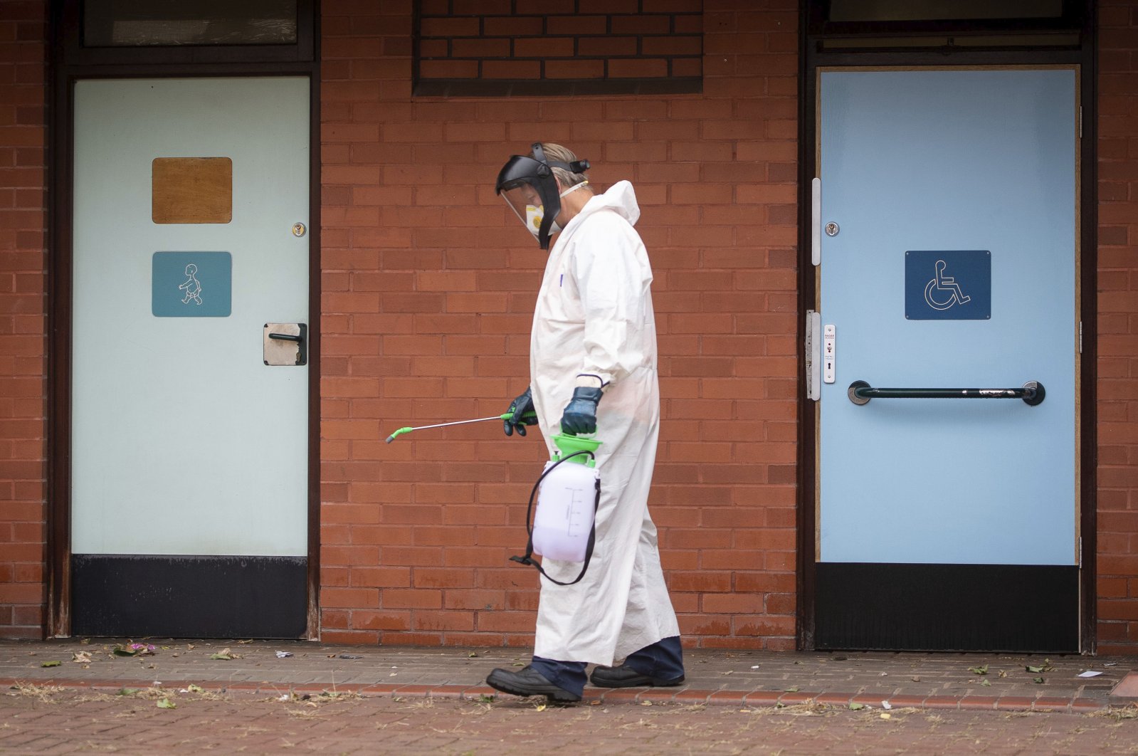 A worker for Leicester City Council disinfects public toilets, Leicester, June 29, 2020. (AP Photo)