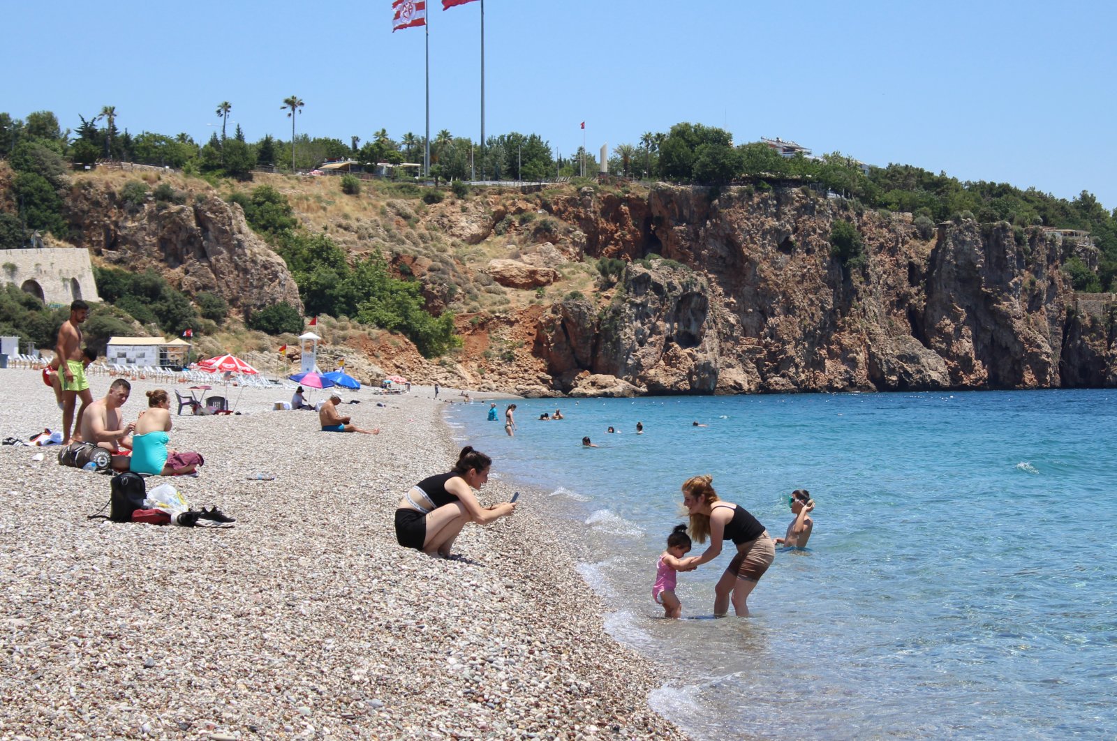 People swim and sunbathe in Antalya, Turkey, June 28, 2020. (DHA Photo)