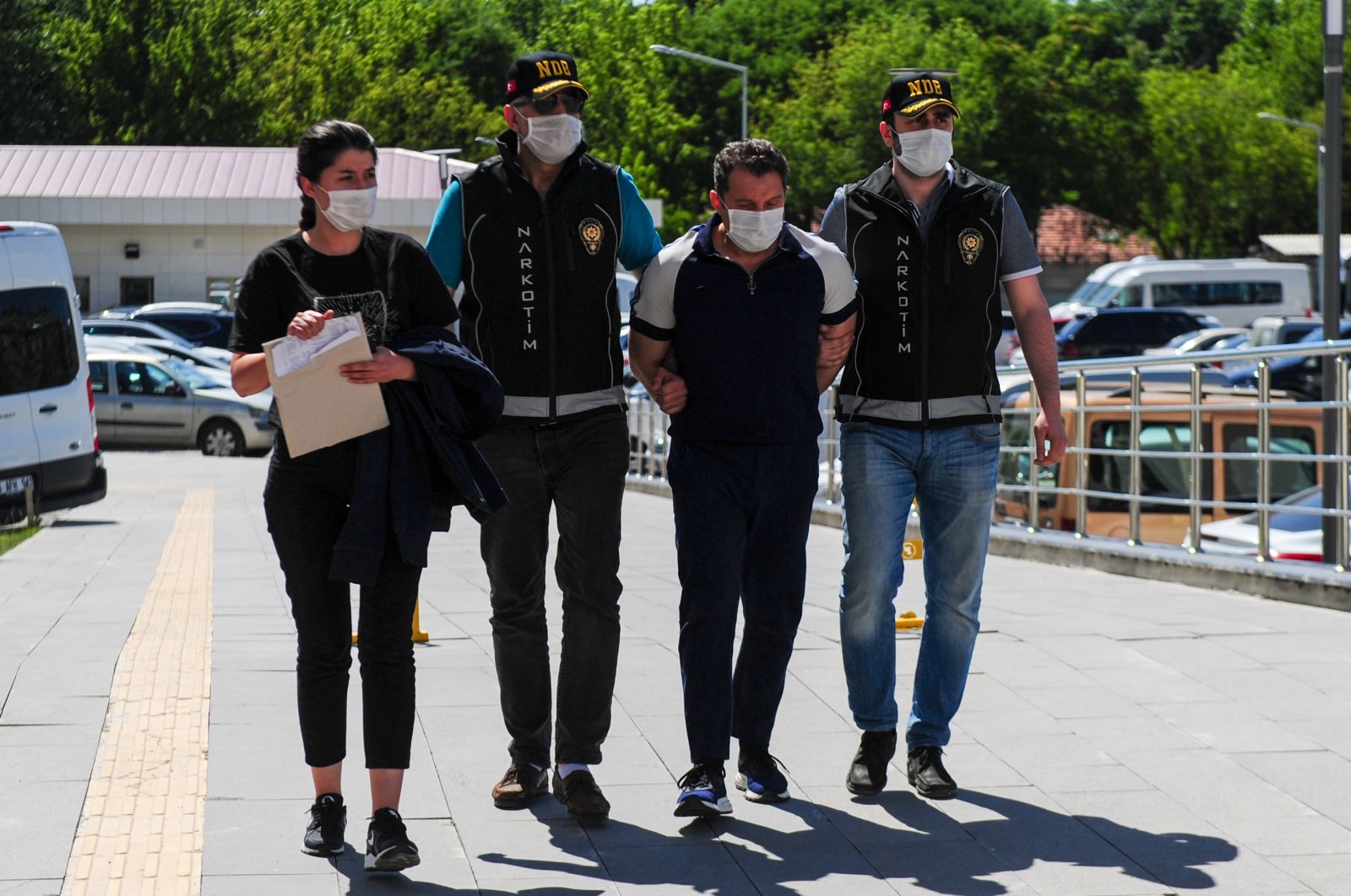 Police officers escort Nejat Daş, one of the suspects, to the police headquarters, in Ankara, Turkey, June 30, 2020. (İHA Photo) 