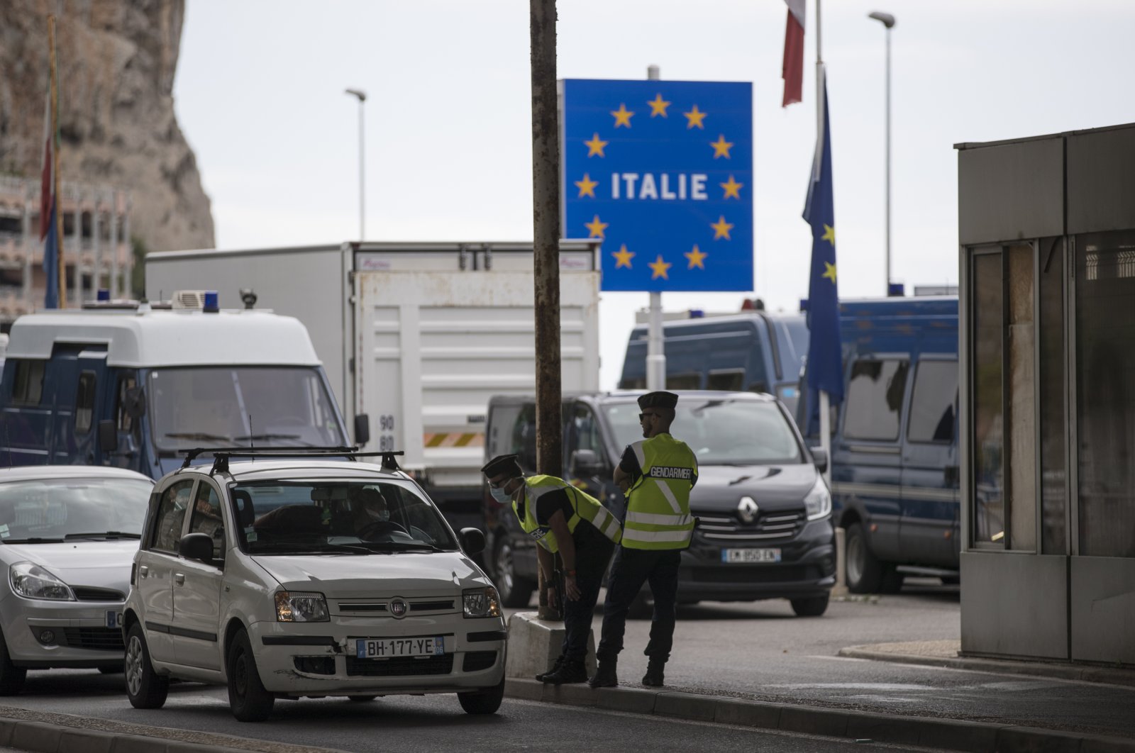 In this Monday, June 15, 2020 file photo, French gendarmes approach a car at the Saint-Ludovic border check point on the Franco-Italian border in Menton, France. (AP Photo)