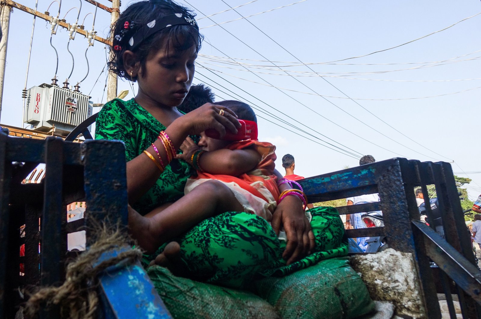 A girl holds a baby at the Aung Mingalar segregation quarter for Rohingya Muslims, Indonesia, May 24, 2020, (AFP Photo)