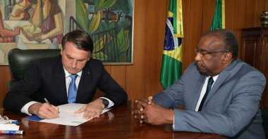 A handout photo released by the Brazilian Presidency press office shows President Jair Bolsonaro (L) and his new Minister of Education Carlos Alberto Decotelli, the first black minister in his Cabinet, at Planalto Palace in Brasilia, Brazil, June 26, 2020. (AFP Photo / Brazilian Presidency)