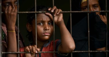 Rohingya from Myanmar look through a fence at the immigration detention center in Lhokseumawe, in Indonesia's North Aceh Regency, June 26, 2020. (AFP Photo)