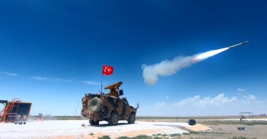 A domestic air defense system is mounted on an armored vehicle in a screenshot from a video showing its test firing. (Defense Industries Presidency via AA )