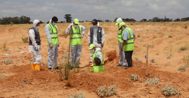 Members of the Government of National Accord's (GNA) missing persons bureau search for human remains in mass graves discovered in areas liberated from Khalifa Haftar's forces, in Tarhuna city, Libya, June 23, 2020. (Reuters Photo)