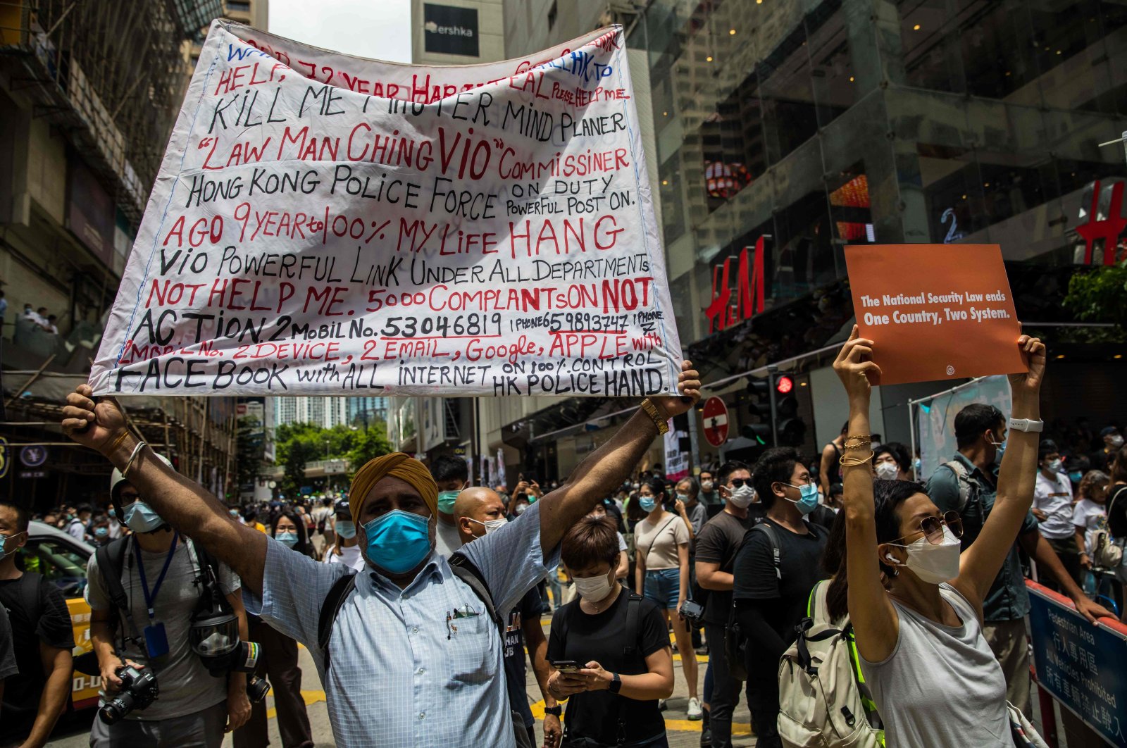 Protesters display banners during a rally against a new national security law in Hong Kong on July 1, 2020, on the 23rd anniversary of the city's handover from Britain to China. (AFP Photo)