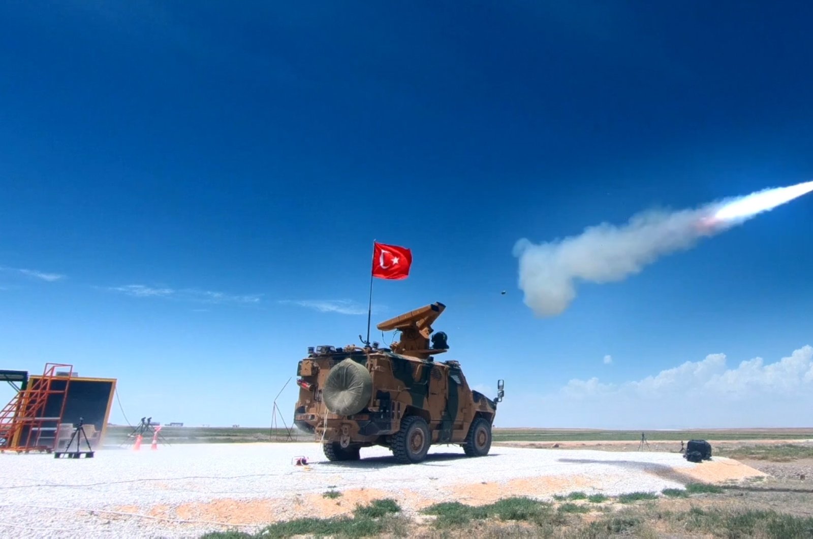A domestic air defense system is mounted on an armored vehicle in a screenshot from a video showing its test firing. (Defense Industries Presidency via AA )