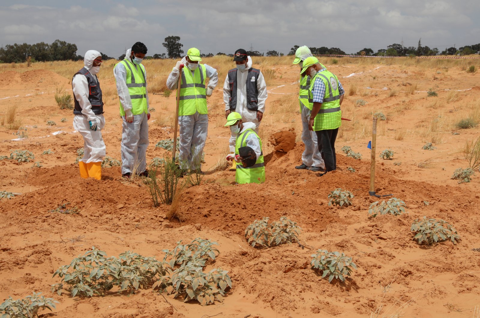 Members of the Government of National Accord's (GNA) missing persons bureau search for human remains in mass graves discovered in areas liberated from Khalifa Haftar's forces, in Tarhuna city, Libya, June 23, 2020. (Reuters Photo)